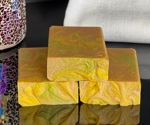 Yellow, green and gold swirled soap with green glitter on top, scented with lemongrass.