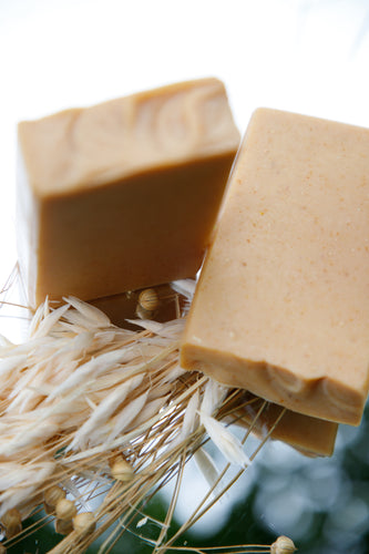 Sunstone Goat Milk Soap bar, marbled in golden turmeric hues, scented with saffron and cedar, artisan-made with a creamy lather

