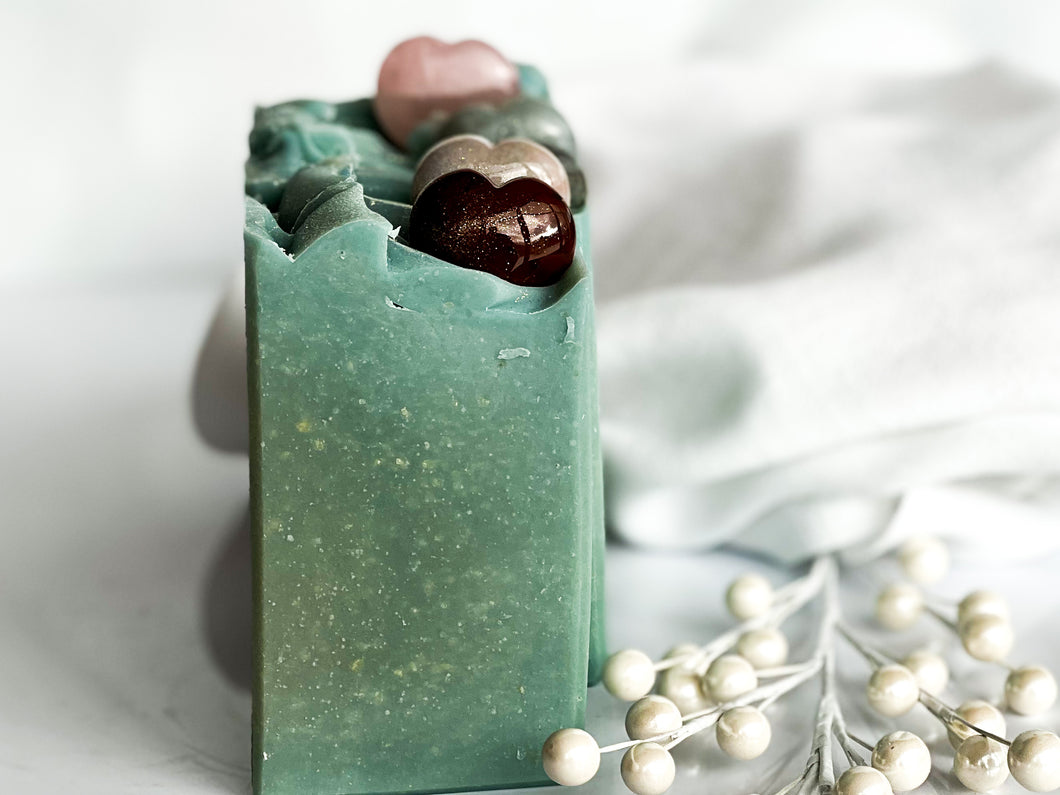 blue green colored goats milk soap topped with polished gemstone puffy heart